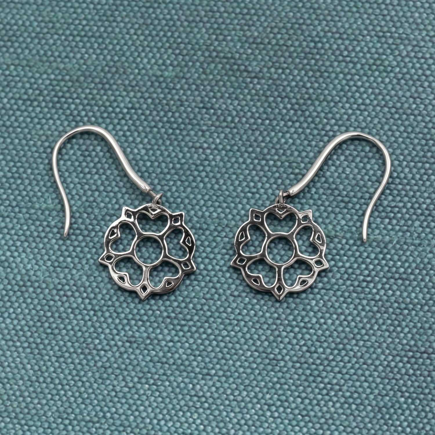 Delicate sterling silver drop earrings featuring an openwork Yorkshire rose motif with fine detailing, designed for elegant, contemporary silver jewellery by Azendi.