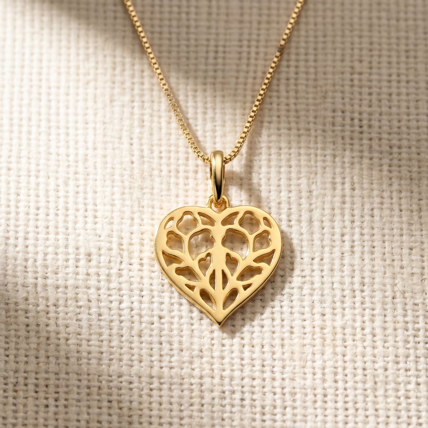 Gold vermeil pendant shaped as an openwork heart with a delicate Yorkshire-inspired leaf motif, suspended on a fine matching chain, showcasing refined craftsmanship.