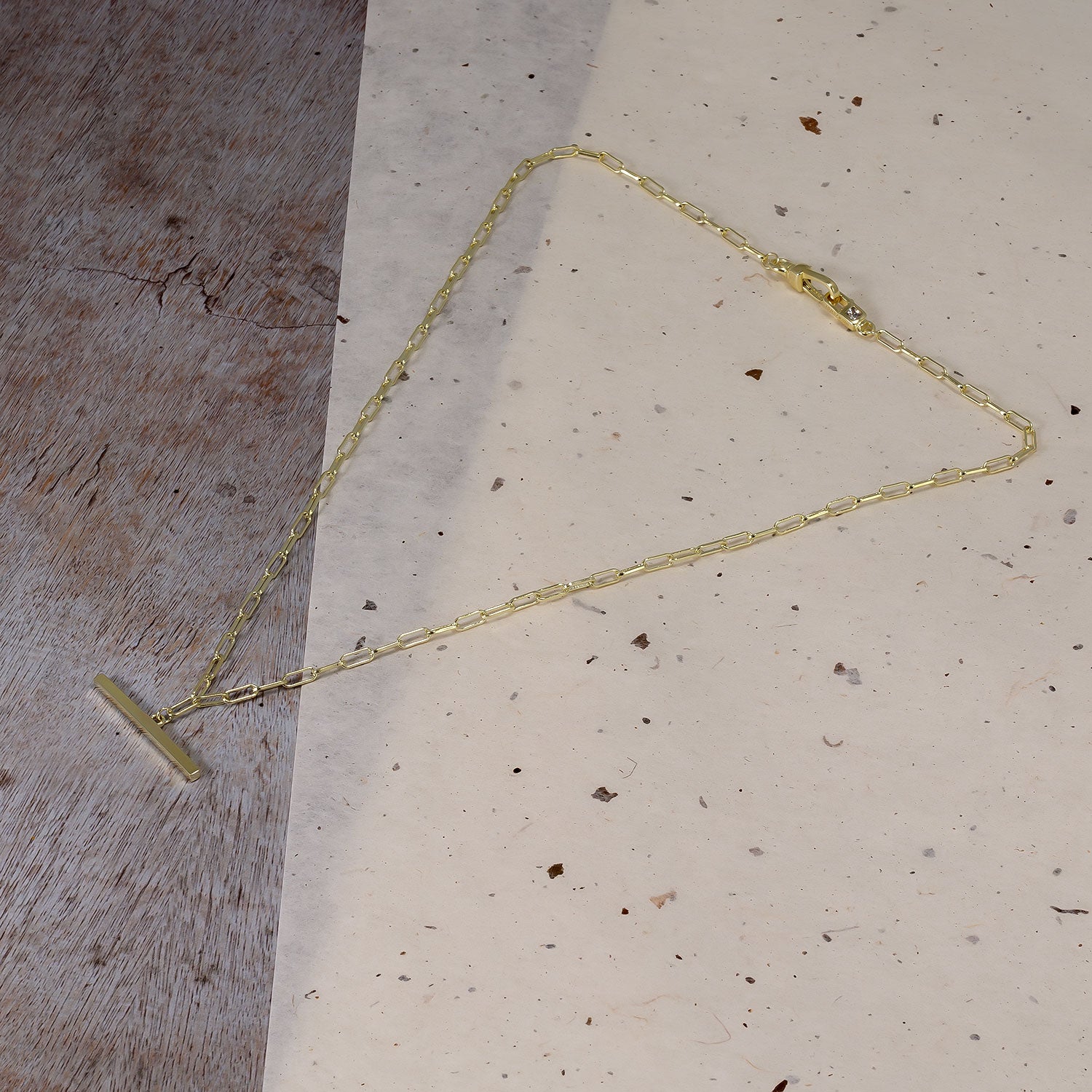 Delicate gold vermeil necklace featuring a T-bar fob and clip clasp on a finely linked chain, exemplifying modern elegance in sterling silver jewellery design.