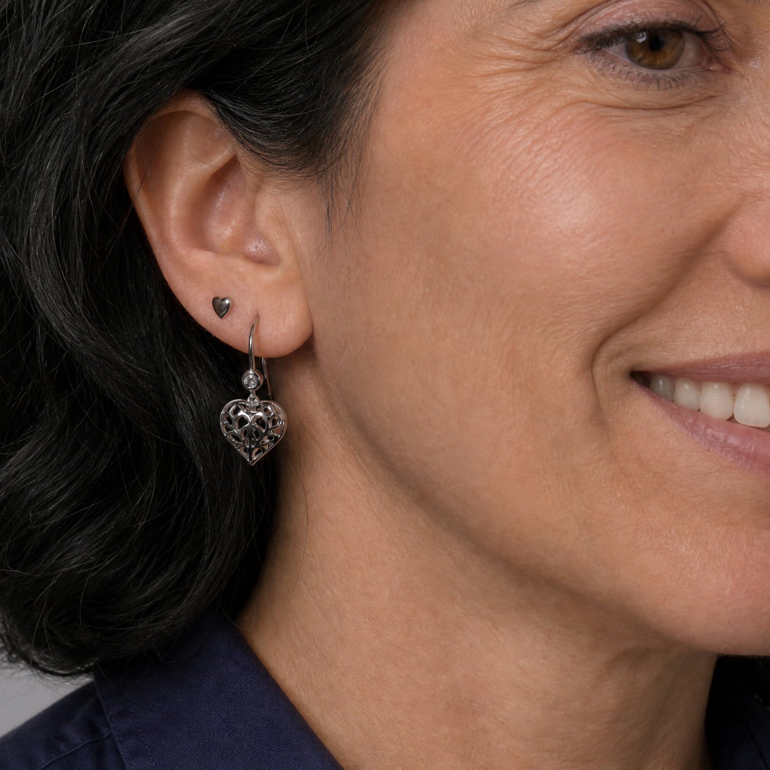 Pair of Lab grown diamond and sterling silver drop earrings featuring delicate, sculptural hanging hearts with intricate cut-out detailing, designed for elegant everyday wear.