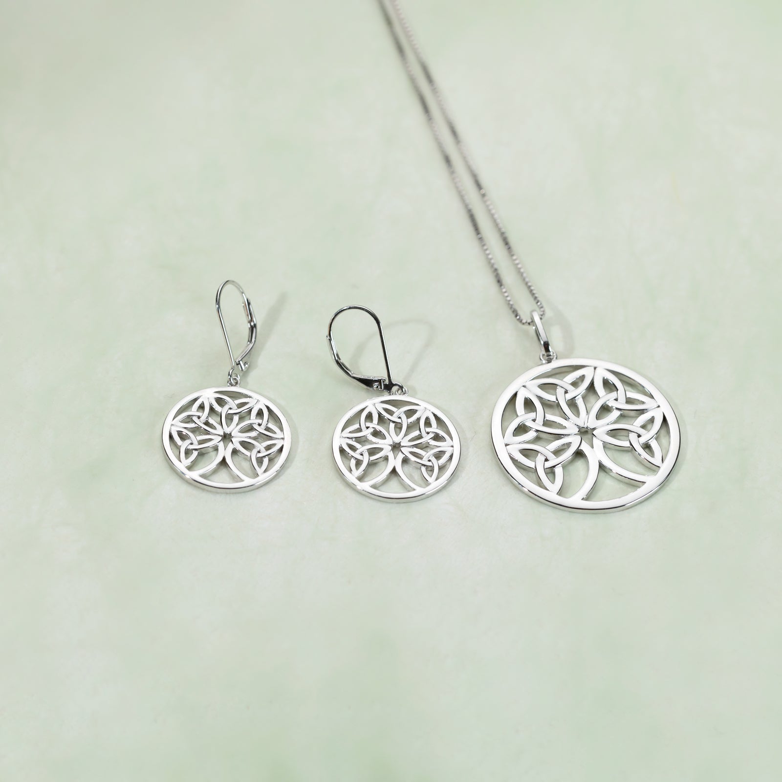 Pair of silver drop earrings featuring a round Celtic Tree of Life motif with openwork design, embodying elegant and sculptural sterling silver jewellery by Azendi.