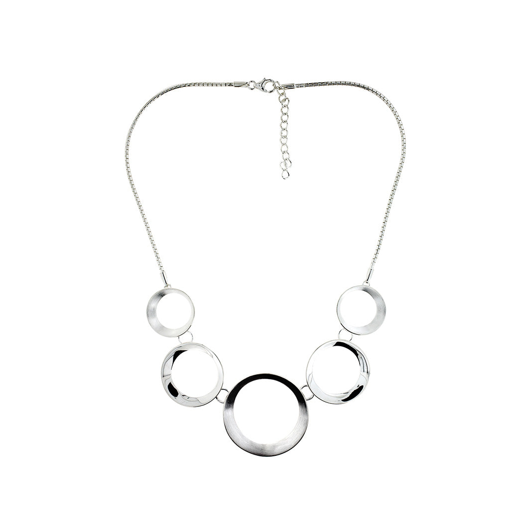 Adjustable sterling silver necklace featuring a series of polished satin-finish circles, creating a modern and sculptural statement piece in contemporary silver jewellery.