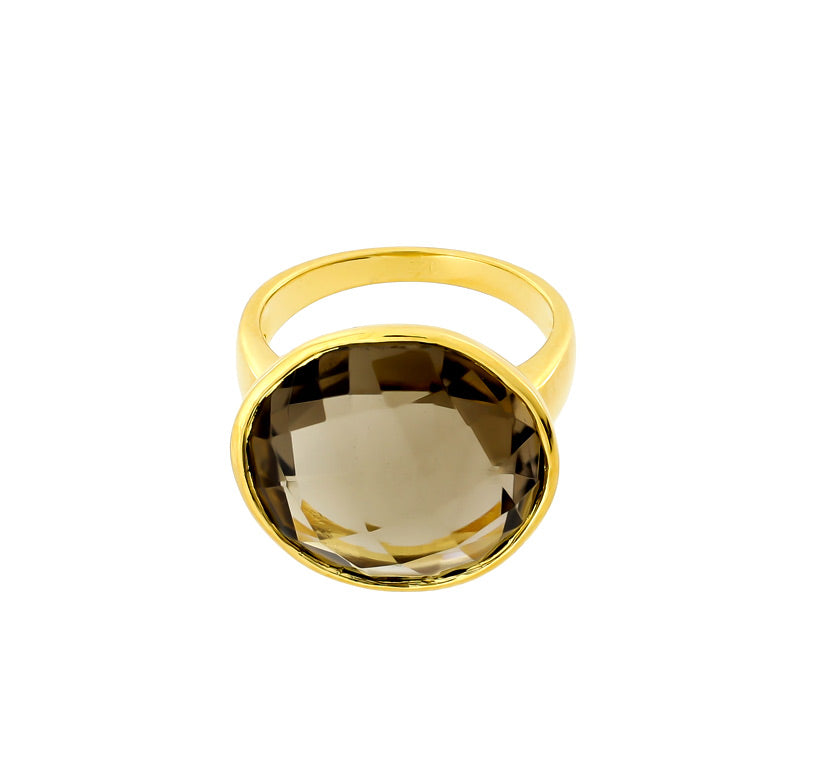 Gold vermeil ring featuring a large faceted smoky quartz gemstone set in a polished bezel, highlighting a sculptural and sophisticated design from a British silver jewellery brand.