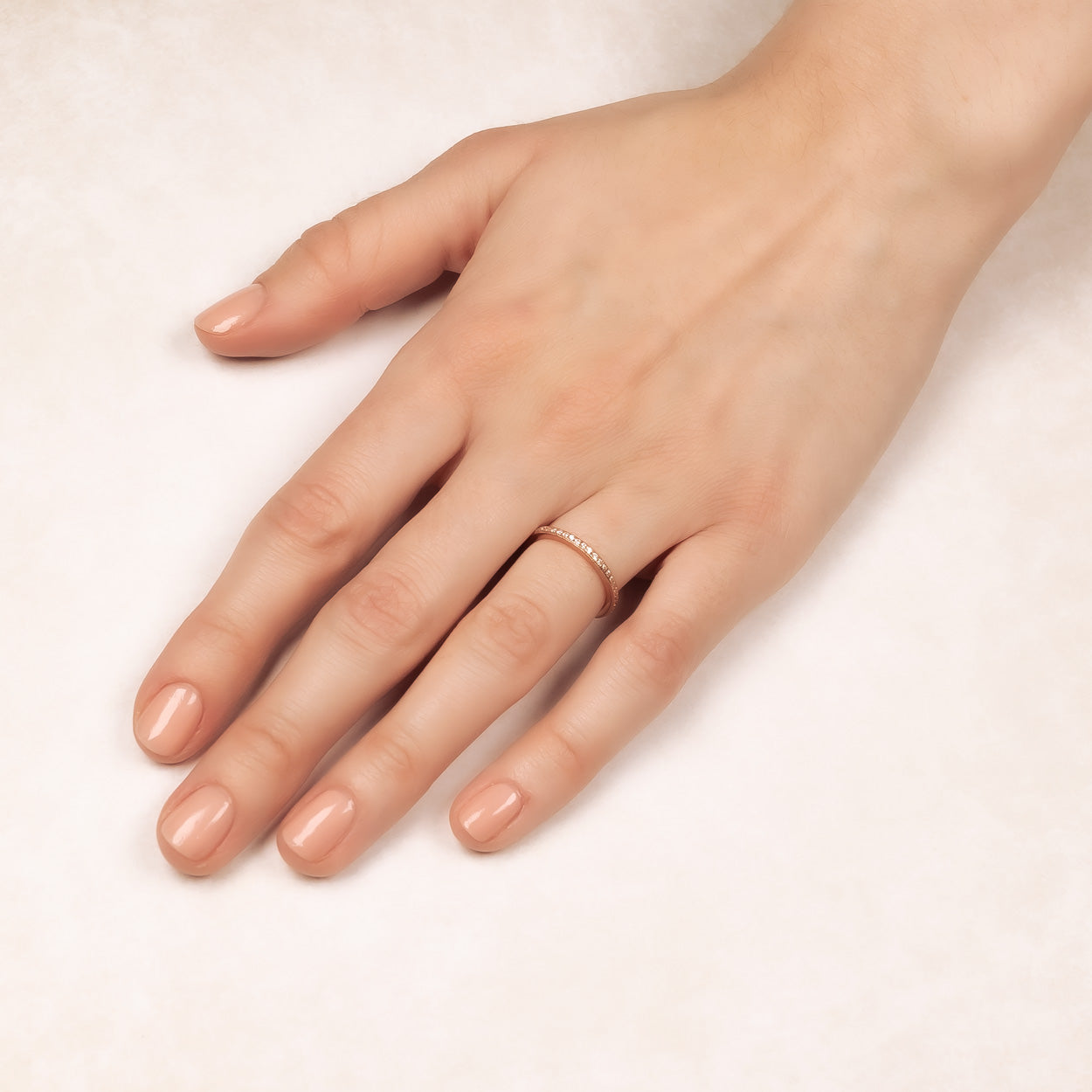 Rose gold vermeil eternity ring with pavé-set stones, elegantly encircling the finger in a refined and slender design by Azendi sterling silver jewellery.