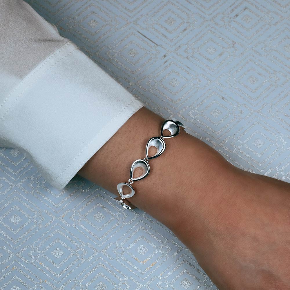 Sterling silver bracelet featuring a series of polished teardrop-shaped links, offering a smooth, sculptural design with contemporary elegance.