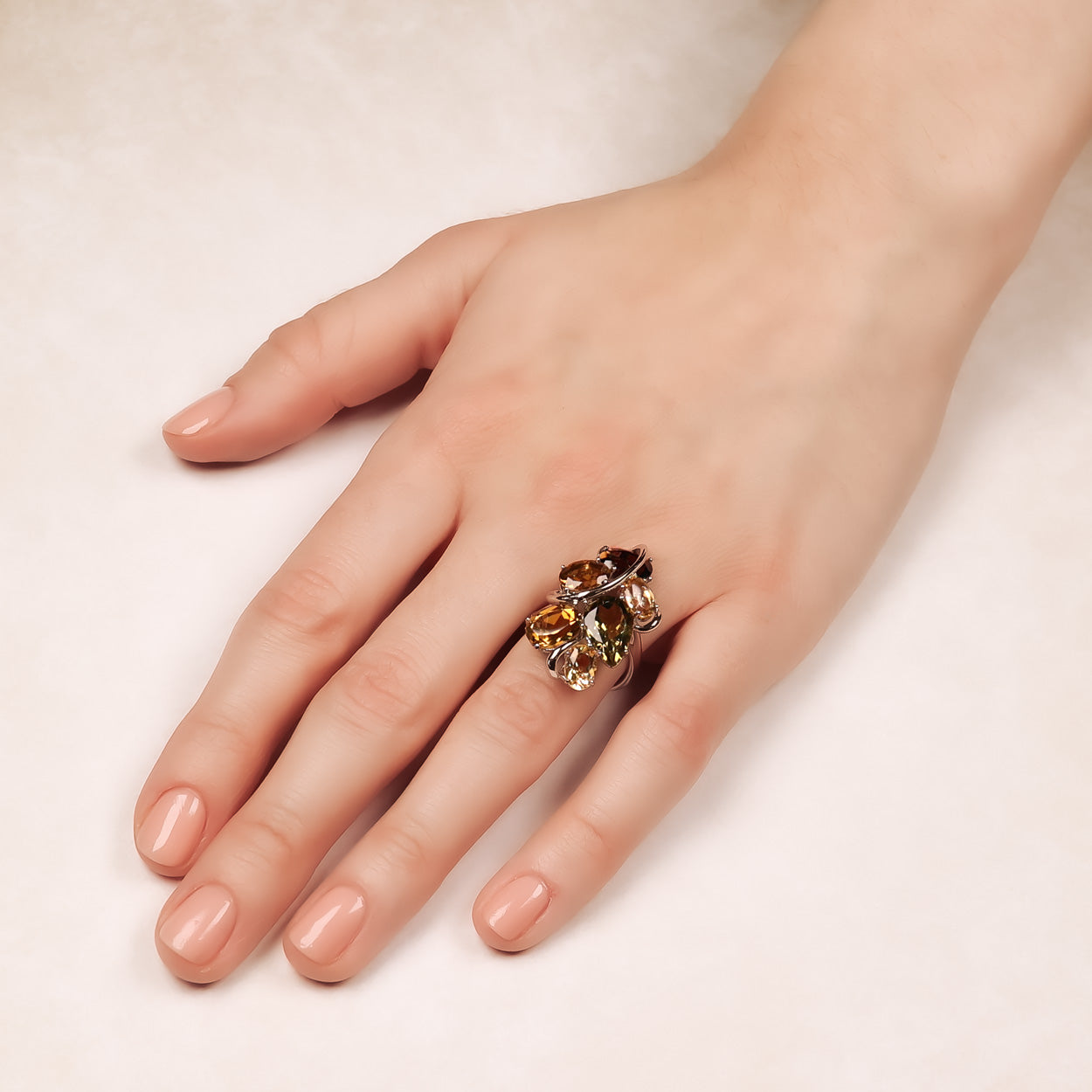 Sterling silver ring featuring a cluster of citrine and smoky quartz gemstones in an elegant sculptural design, showcasing striking colour contrast and contemporary style.