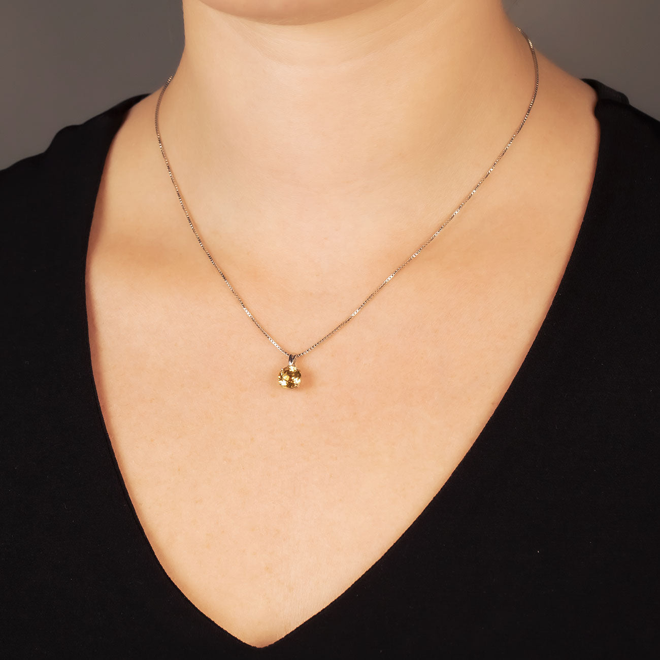 Delicate sterling silver necklace featuring a brilliant cut citrine pendant, showcasing a refined and sculptural design for an elegant jewellery statement.