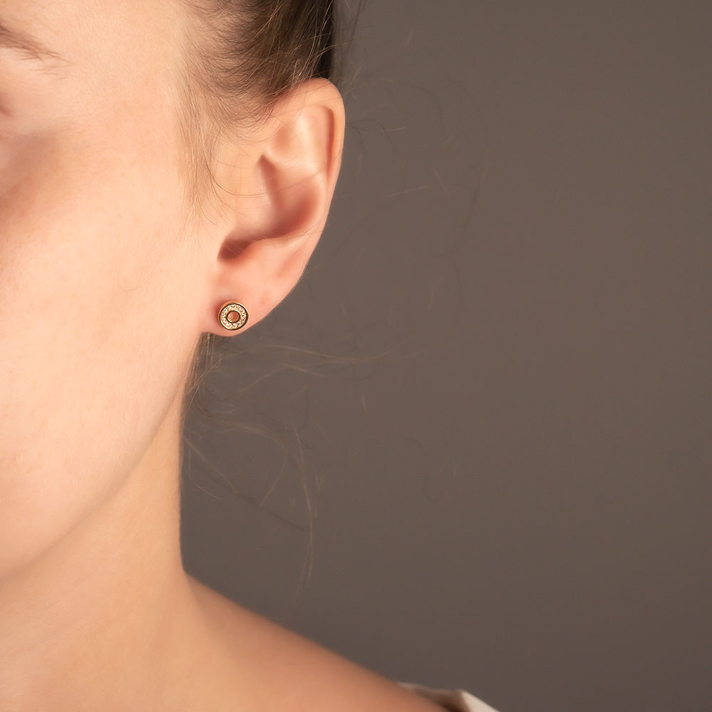 Ear adorned with a sterling silver stud earring featuring an open circle design embellished with pavé-set stones, showcasing refined contemporary silver jewellery.
