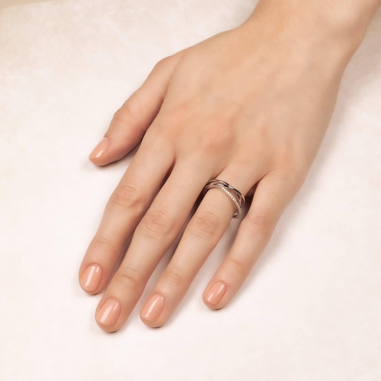Sterling silver pavé ring featuring a double-band design with sparkling stones, worn on a hand with a natural, polished nail look, showcasing elegant contemporary jewellery.
