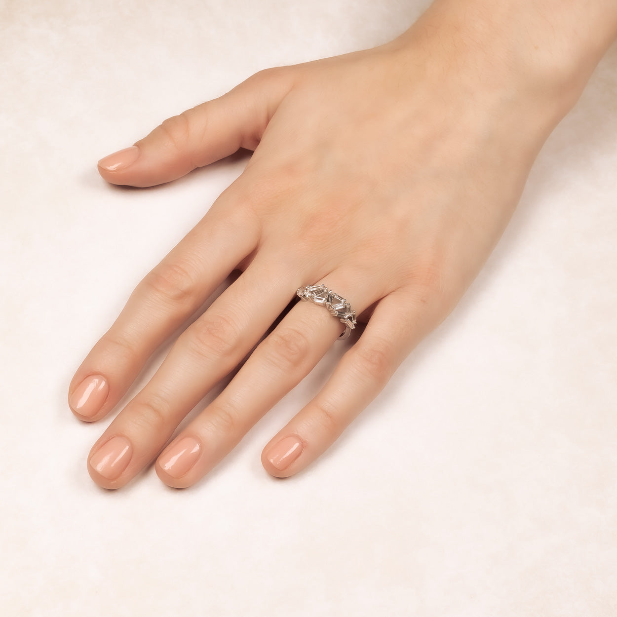 Sterling silver ring featuring clustered baguette-cut stones arranged in a sculptural design, worn on the finger for a refined and contemporary look.