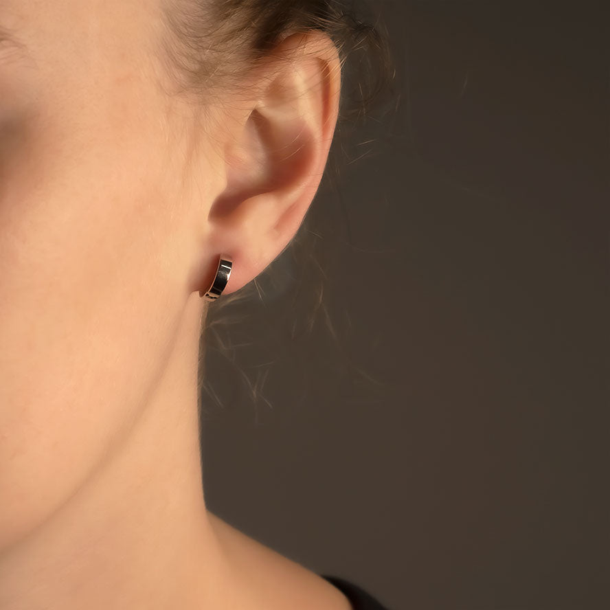 Sleek sterling silver small squared hoop earring with a polished finish, showcasing a minimalist and sculptural design in fine silver jewellery by Azendi.
