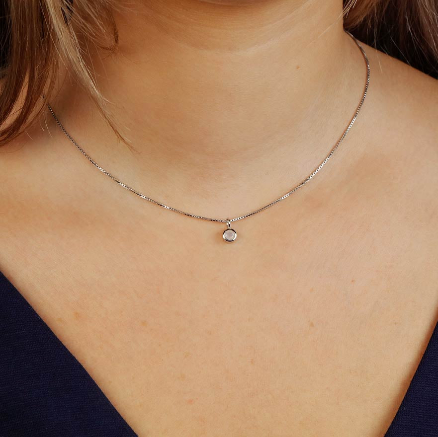 Delicate sterling silver necklace featuring a small aqua chalcedony pendant, highlighting a refined and modern design by an award-winning British jeweller.
