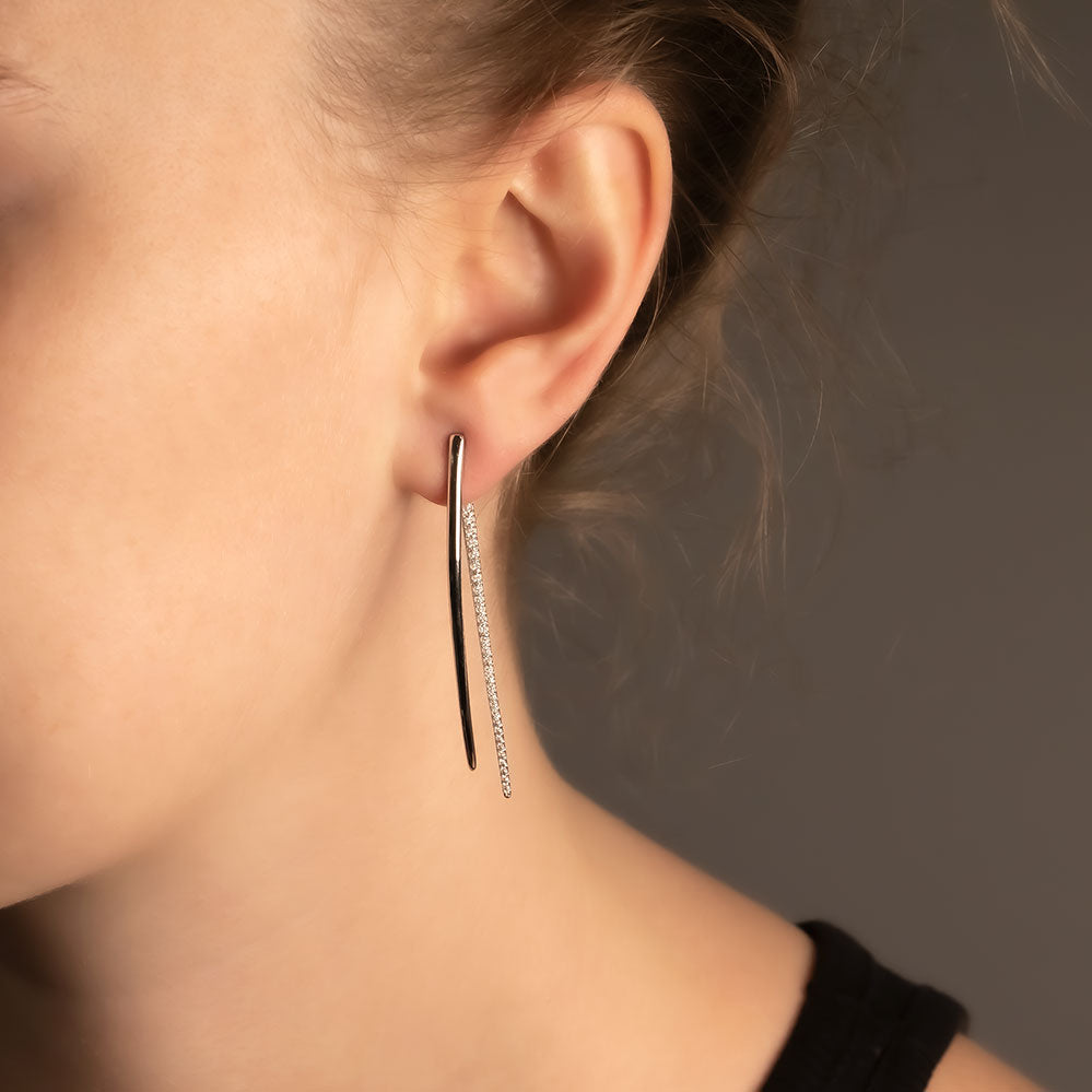 Pair of contemporary sterling silver earrings featuring a balanced double curl design with pavé detailing, showcasing elegant sculptural lines and refined craftsmanship.
