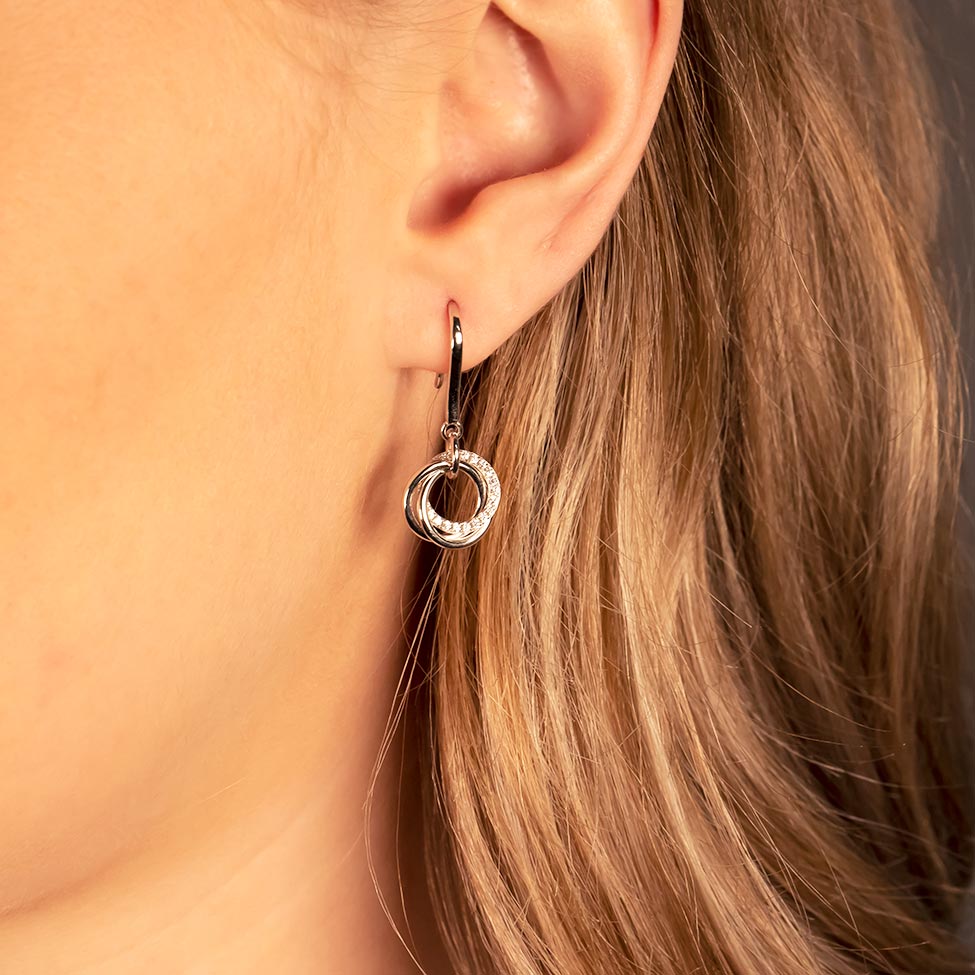 Delicate mixed vermeil drop earring featuring interconnected love knot circles with pavé accents, showcasing a refined and sculptural design in contemporary sterling silver jewellery.