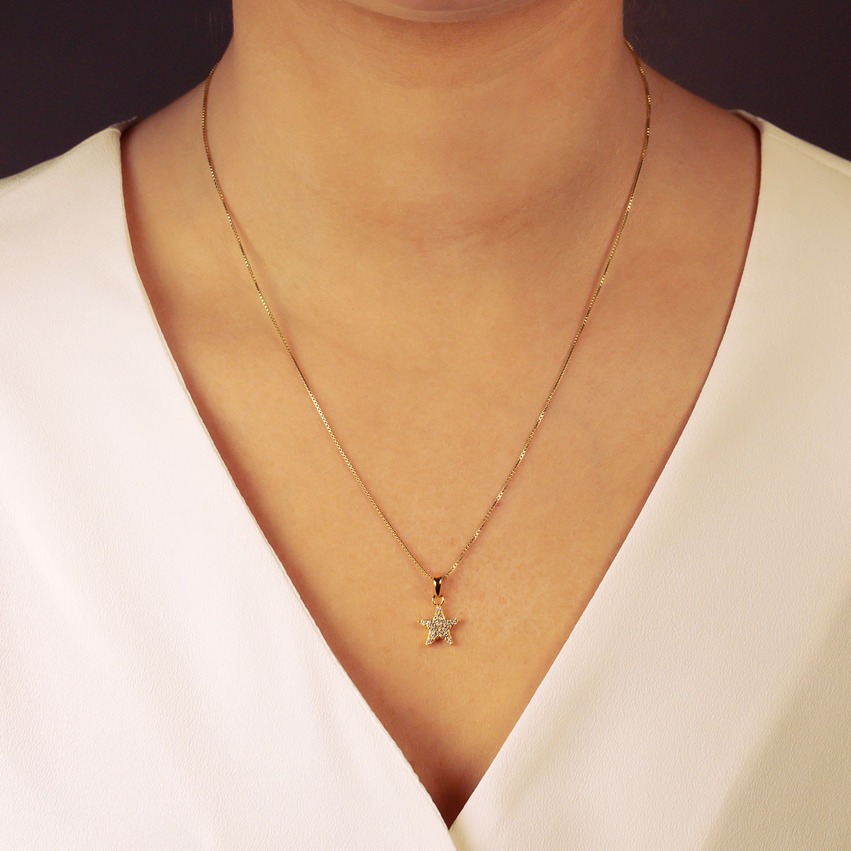 Delicate yellow gold vermeil necklace featuring a small pavé-set star pendant, offering a refined and sculptural addition to sterling silver and gold vermeil jewellery collections.