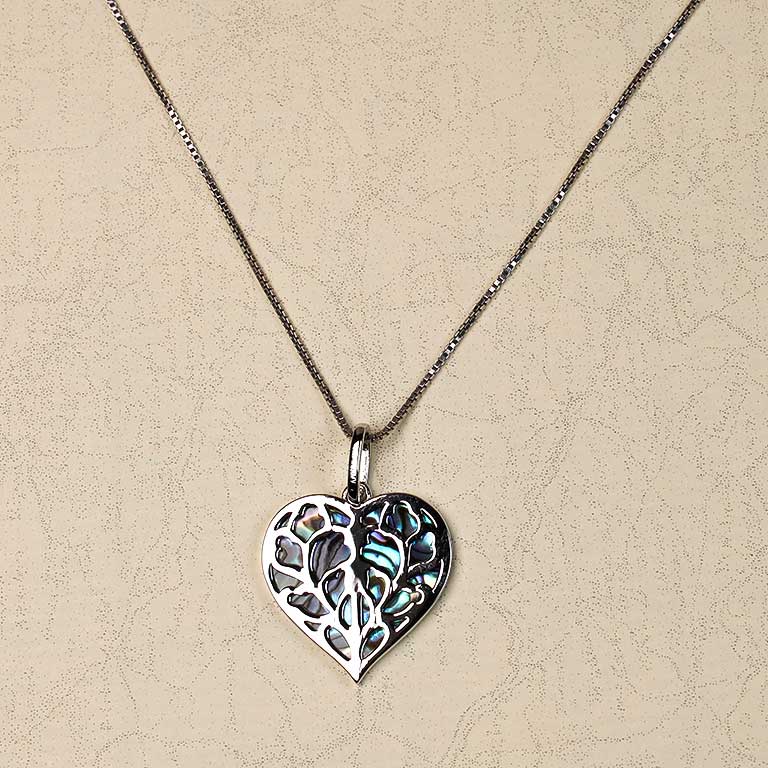 Sterling silver pendant featuring an openwork heart design with iridescent abalone inlay, suspended from a delicate fine silver chain.