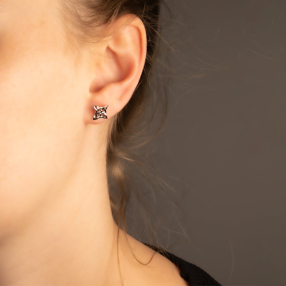 Sterling silver stud earrings featuring a Celtic star design with intricate cut-out detailing, exemplifying sculptural elegance in contemporary silver jewellery.