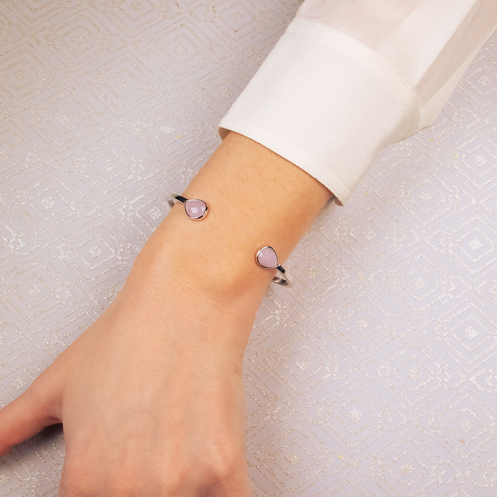 Sterling silver cuff bracelet featuring two teardrop-shaped amethyst gemstones at each end, combining contemporary elegance with a sculptural design.