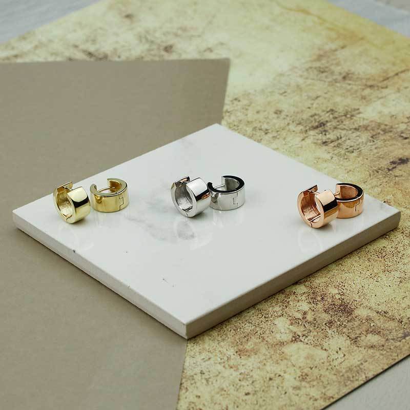 Set of medium wide hinge hoop earrings in polished yellow gold vermeil, sterling silver, and rose gold vermeil, showcasing a bold, contemporary silhouette.