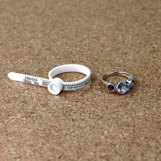 A white plastic ring sizer