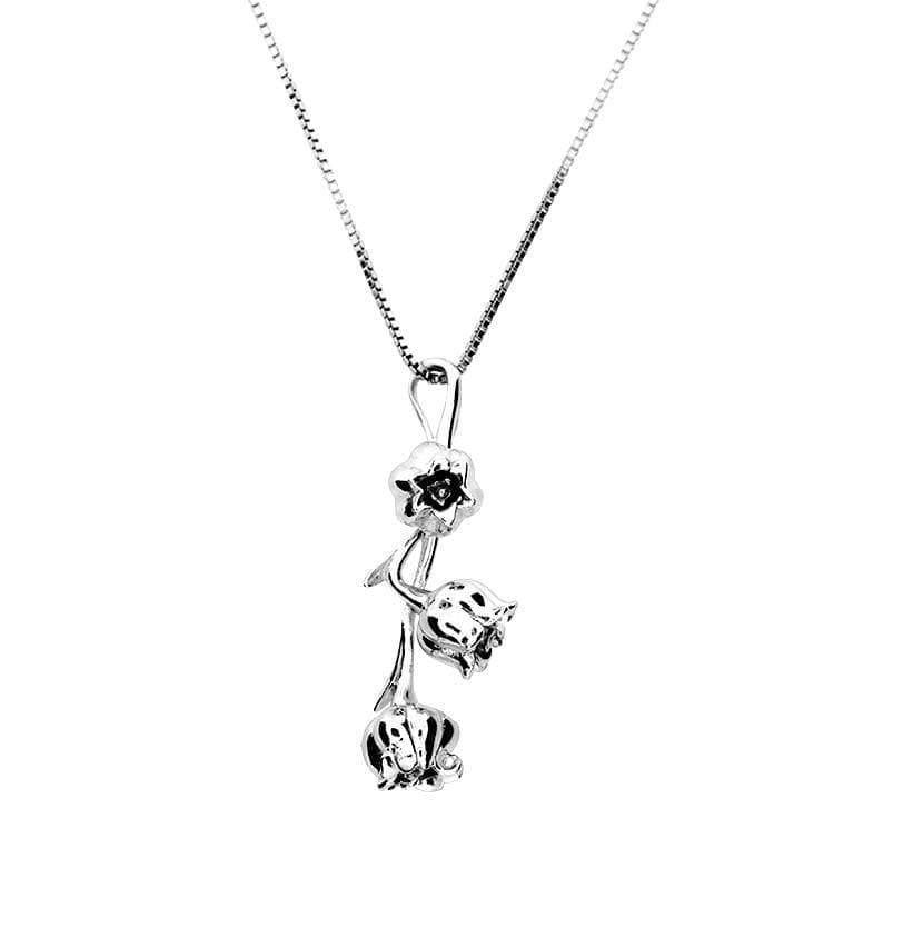 Sterling silver pendant crafted in the shape of delicate Lily of the Valley flowers, suspended from a fine chain, showcasing intricate detailing and refined British design.