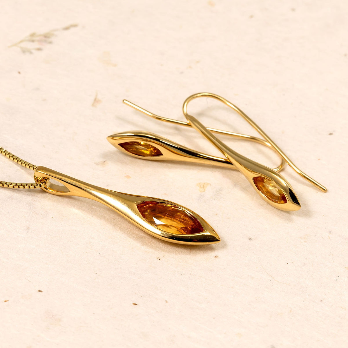 Pair of gold vermeil drop earrings featuring slender marquise-shaped citrine gemstones set within smooth, polished frames for an elegant and refined look.