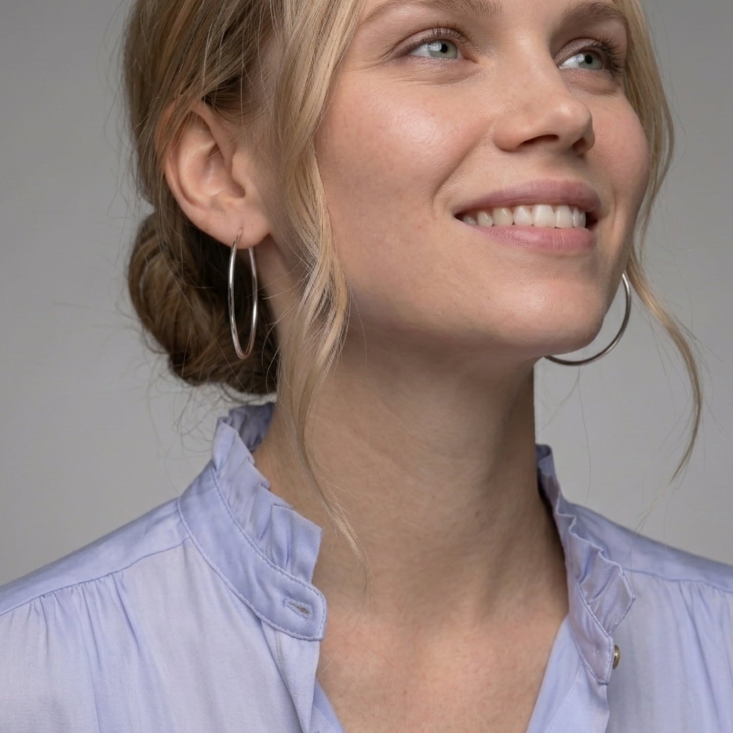 Minimalist sterling silver hoop earring with a smooth polished finish, showcasing a classic and versatile design that complements contemporary silver jewellery styles.