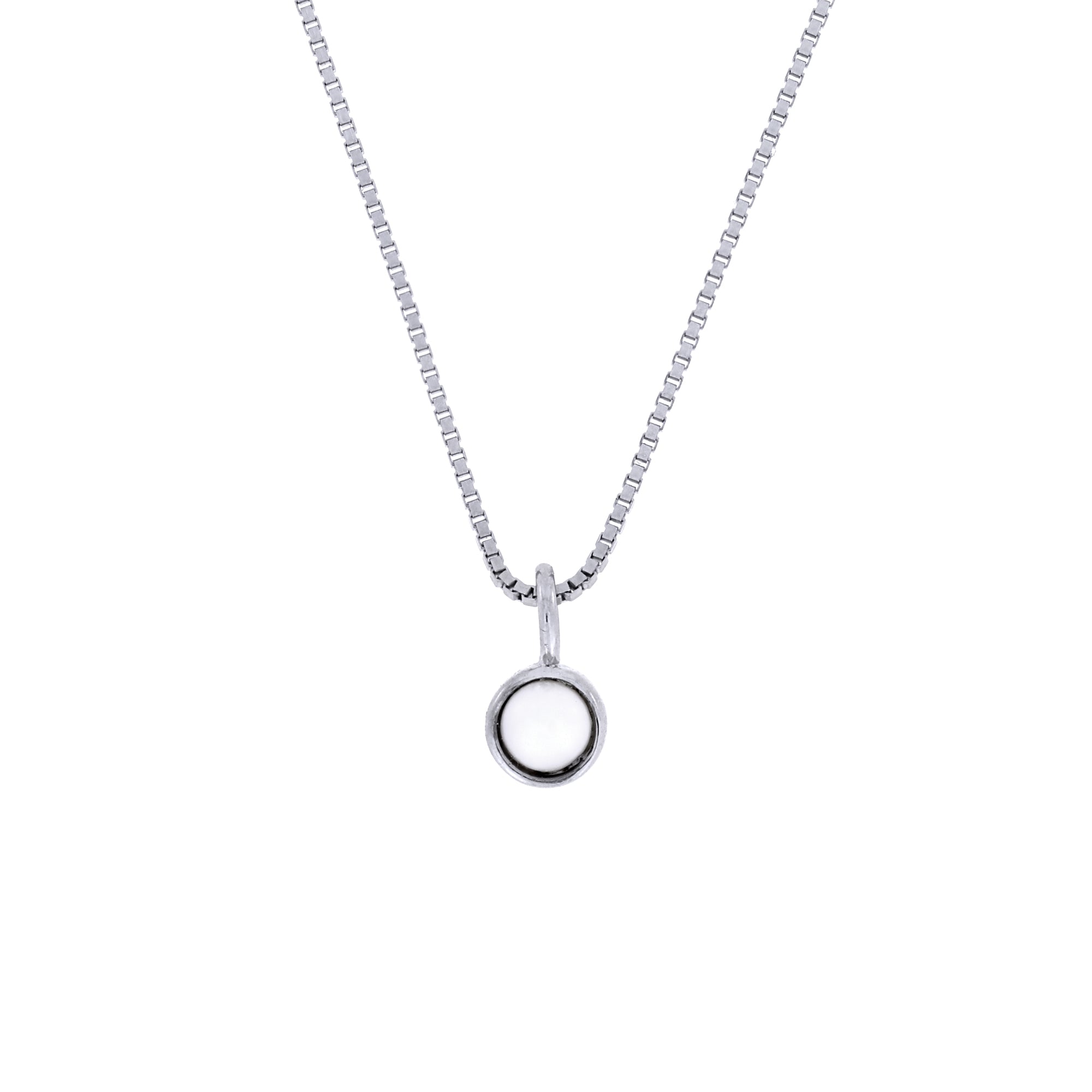 Delicate sterling silver pendant featuring a sculptural bezel-set freshwater pearl suspended from a fine chain, highlighting expert British craftsmanship.