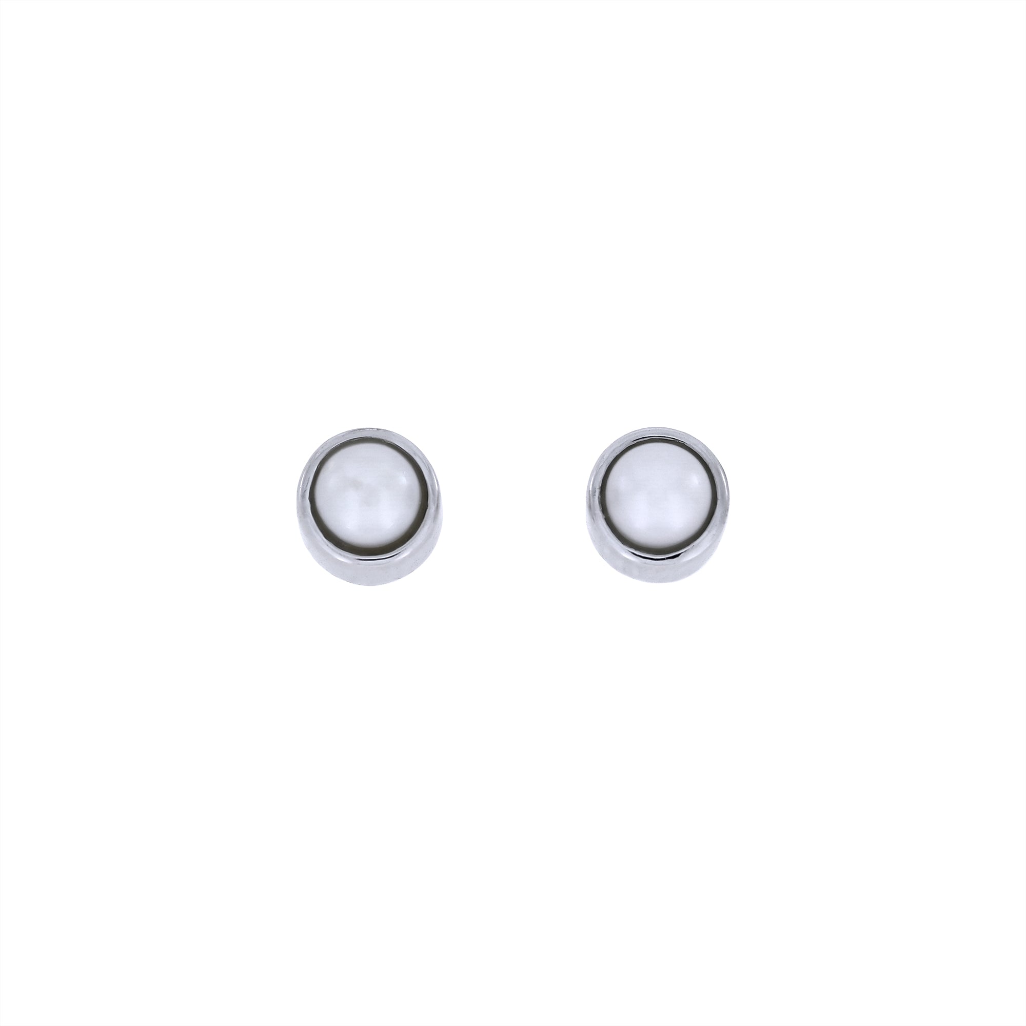 Delicate sterling silver stud earrings featuring a freshwater pearl centre, showcasing a minimalist and refined design with expert British craftsmanship.