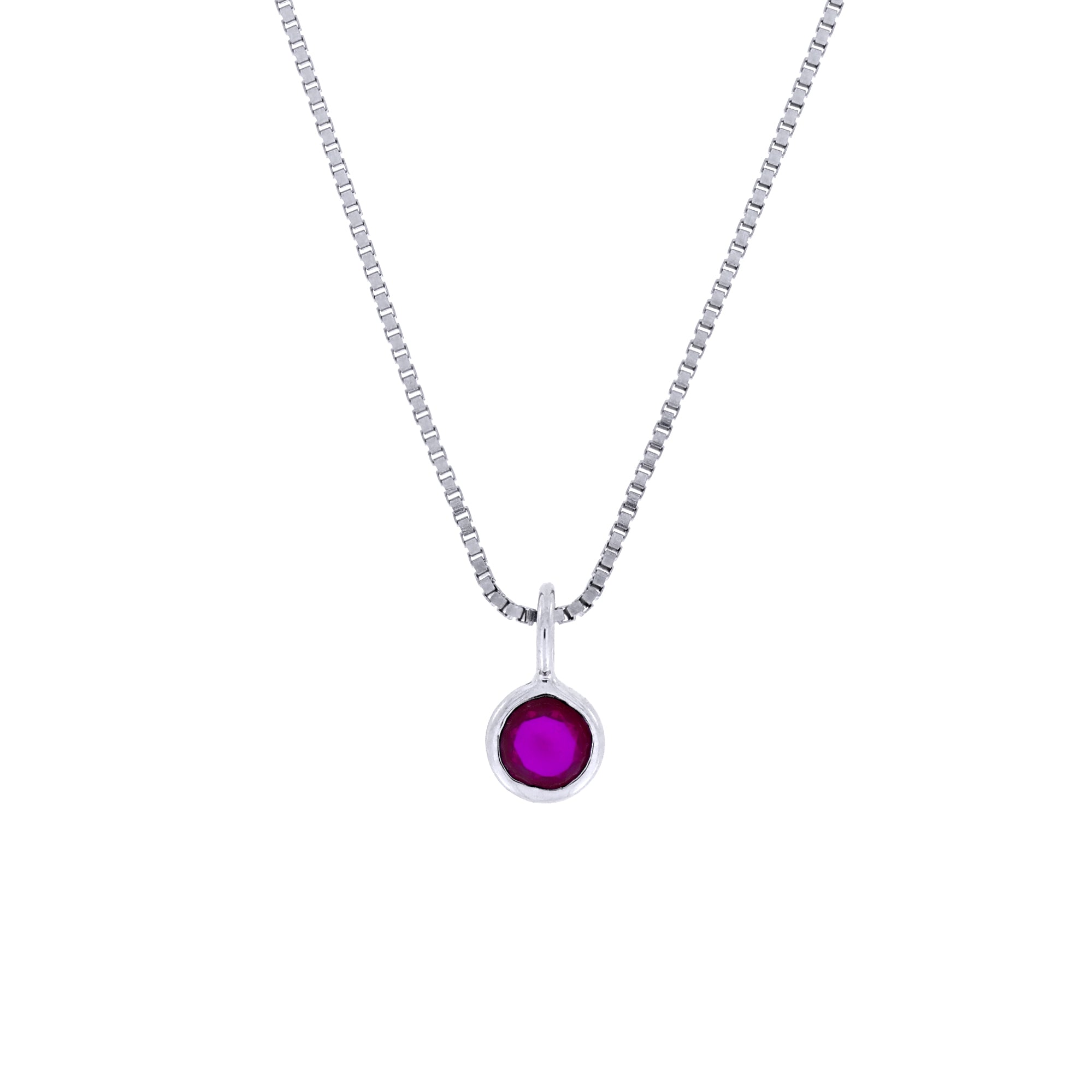 Delicate sterling silver pendant featuring a deep red ruby birthstone, suspended from a fine chain, exemplifying expert British craftsmanship and timeless elegance.