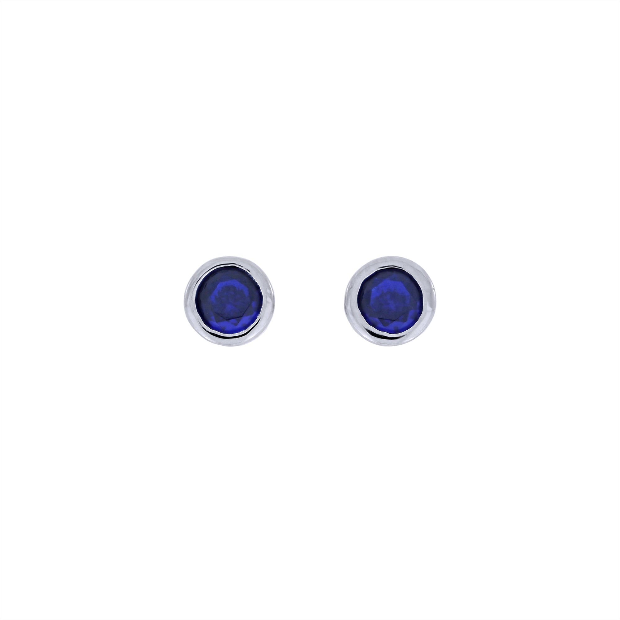 Pair of sterling silver stud earrings set with deep blue spinel gemstones, showcasing a sleek, modern design that combines simplicity with expert British craftsmanship.