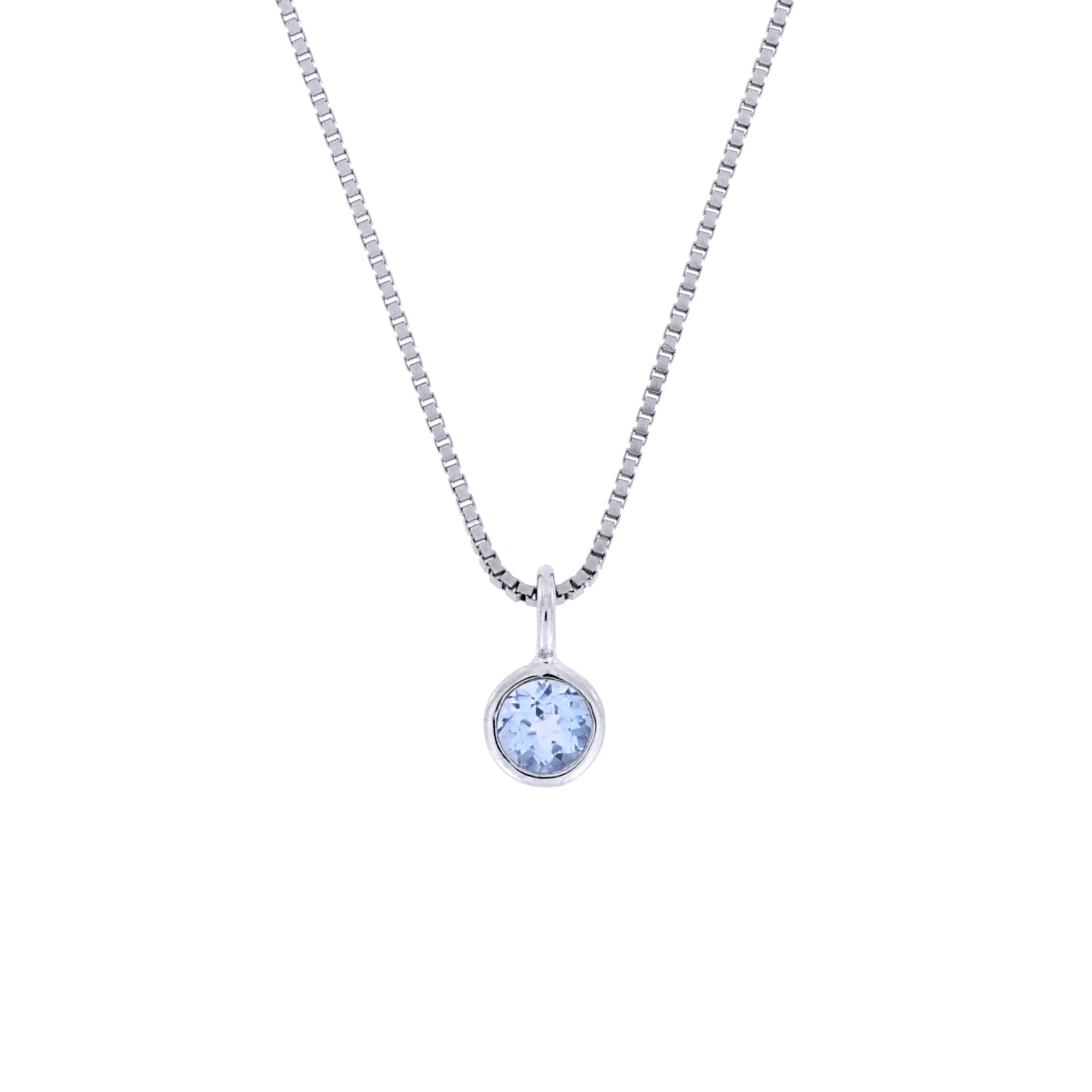 Delicate sterling silver pendant featuring a bezel-set blue topaz, suspended on a fine chain, exemplifying refined British craftsmanship and elegant design.