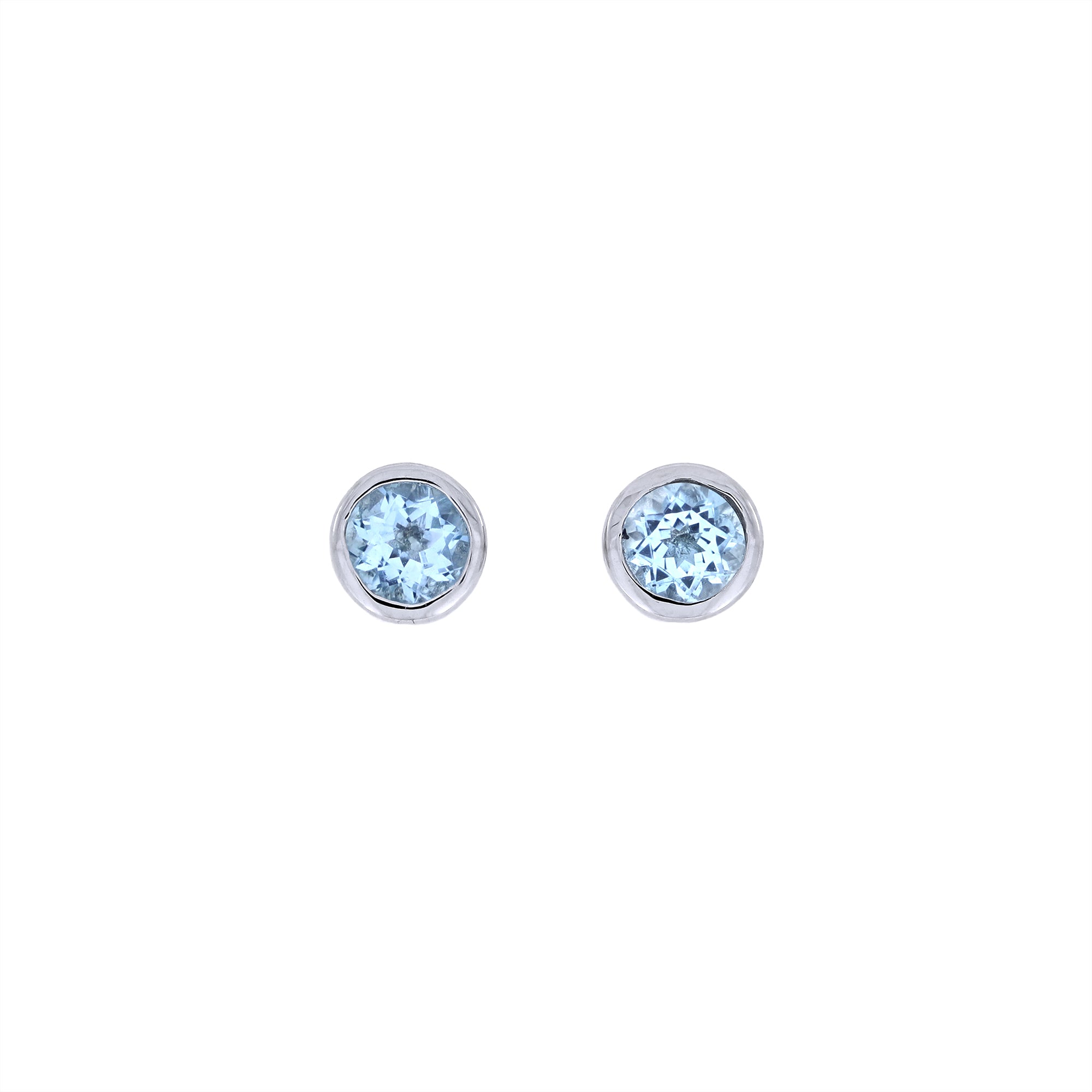 Round sterling silver stud earrings featuring bright blue topaz gemstones, embodying a refined and minimalist design with expert British craftsmanship.