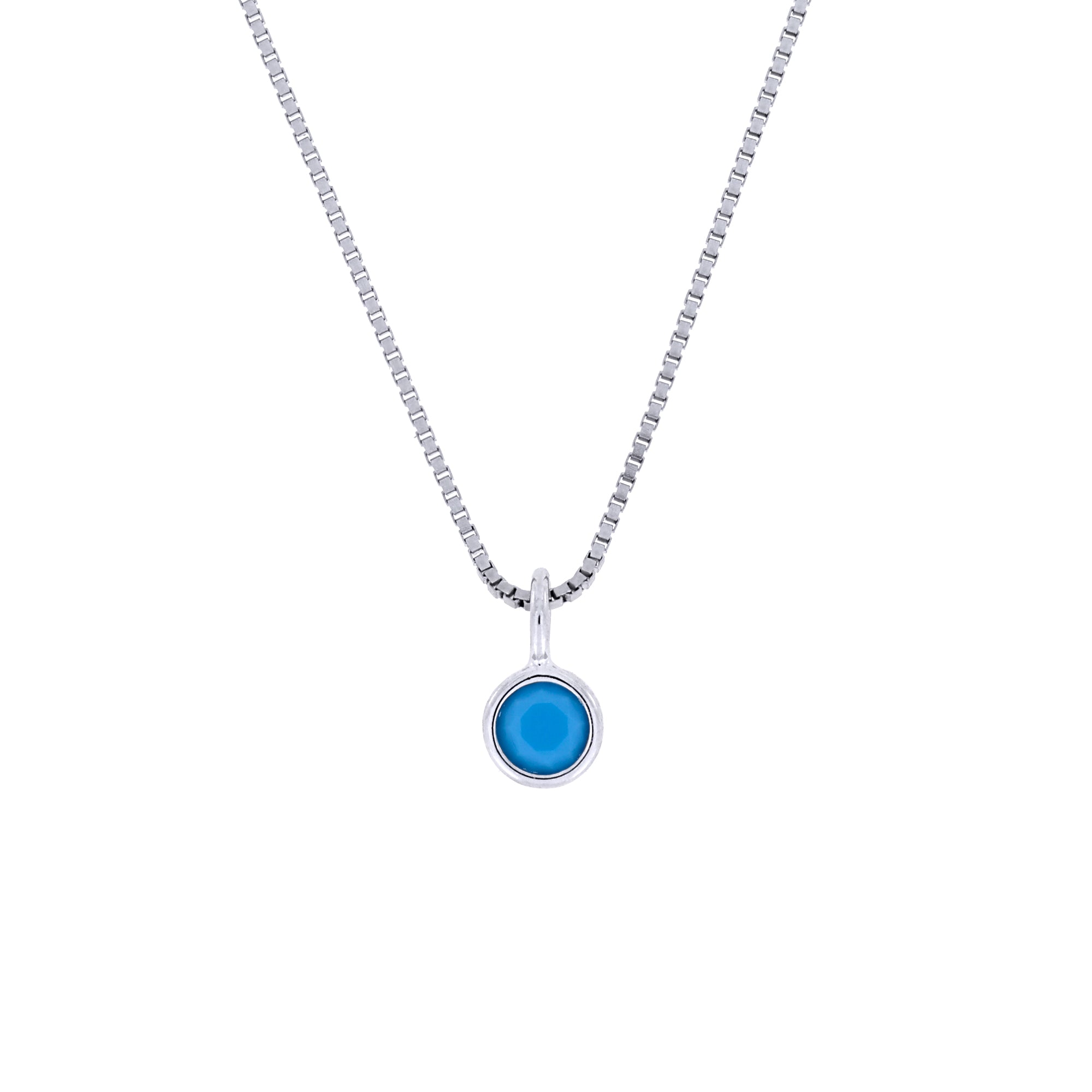 Delicate sterling silver pendant featuring a bezel-set turquoise gemstone, suspended from a fine chain, embodying contemporary British craftsmanship and elegant simplicity.