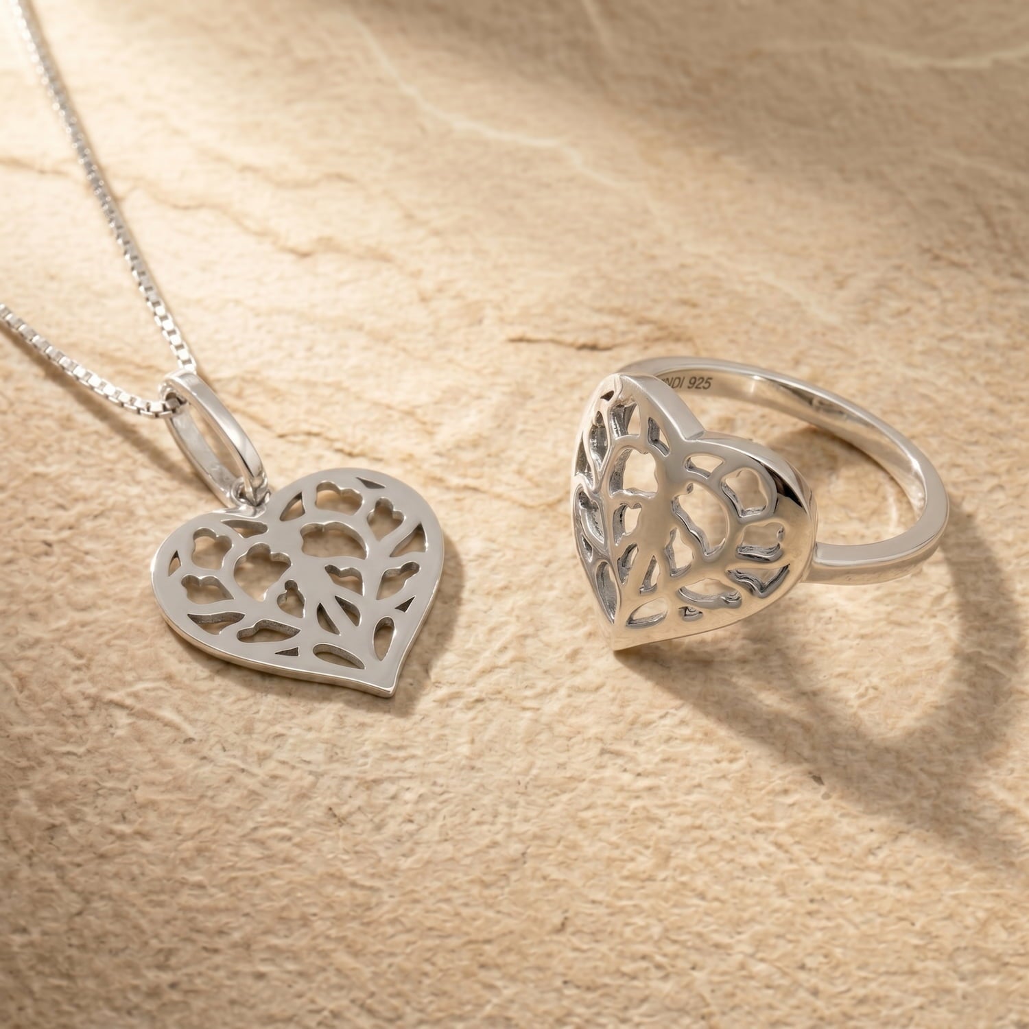 Sterling silver ring and pendant featuring an openwork heart design inspired by Yorkshire, with a slender band and sculptural detailing for a contemporary look. 