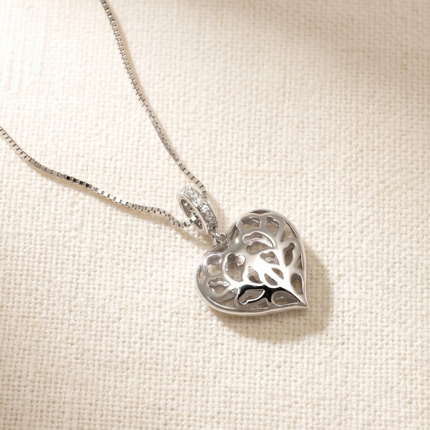Sterling silver pendant featuring an openwork heart design inspired by Yorkshire, suspended from a fine chain, showcasing intricate craftsmanship in silver jewellery.