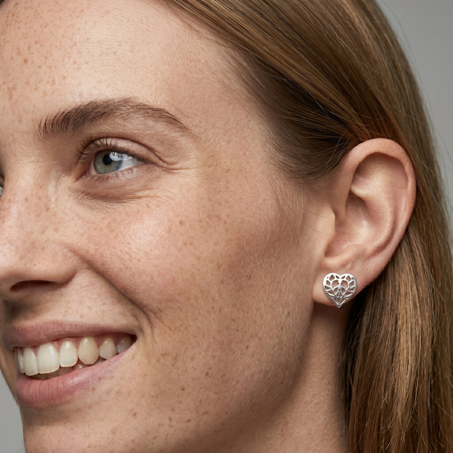 Sterling silver stud earrings shaped as detailed openwork hearts inspired by Yorkshire, showcasing delicate craftsmanship and a sculptural design.