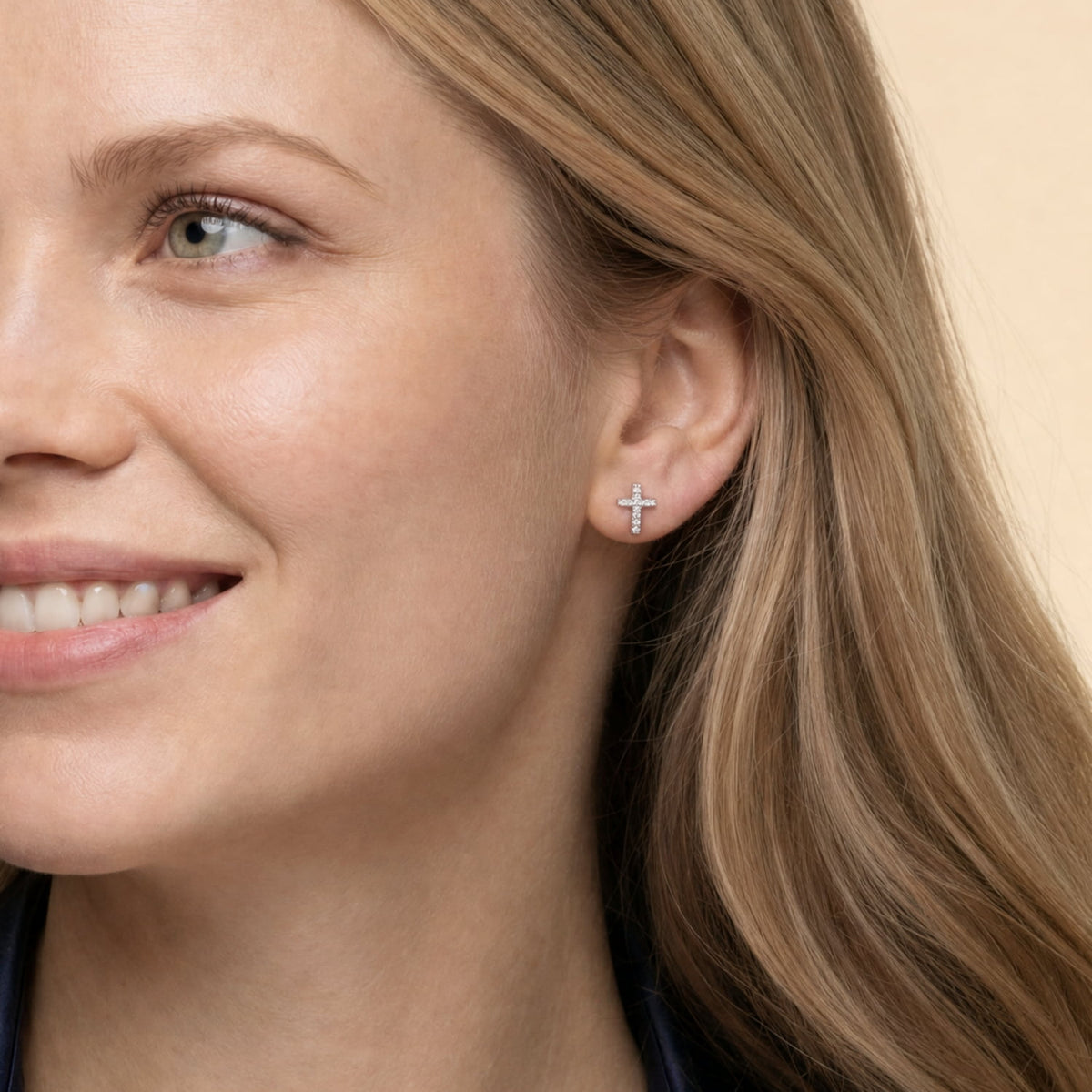 Delicate sterling silver cross stud earrings featuring pavé detailing, designed for a subtle yet refined addition to any contemporary jewellery collection.