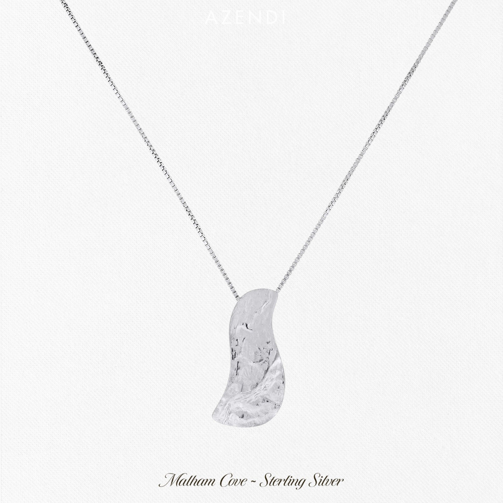 A sterling silver pendant with a textured effect, resembling a curving shape, suspended from a chain, representing the Malham Cove Waterfall Pendant.