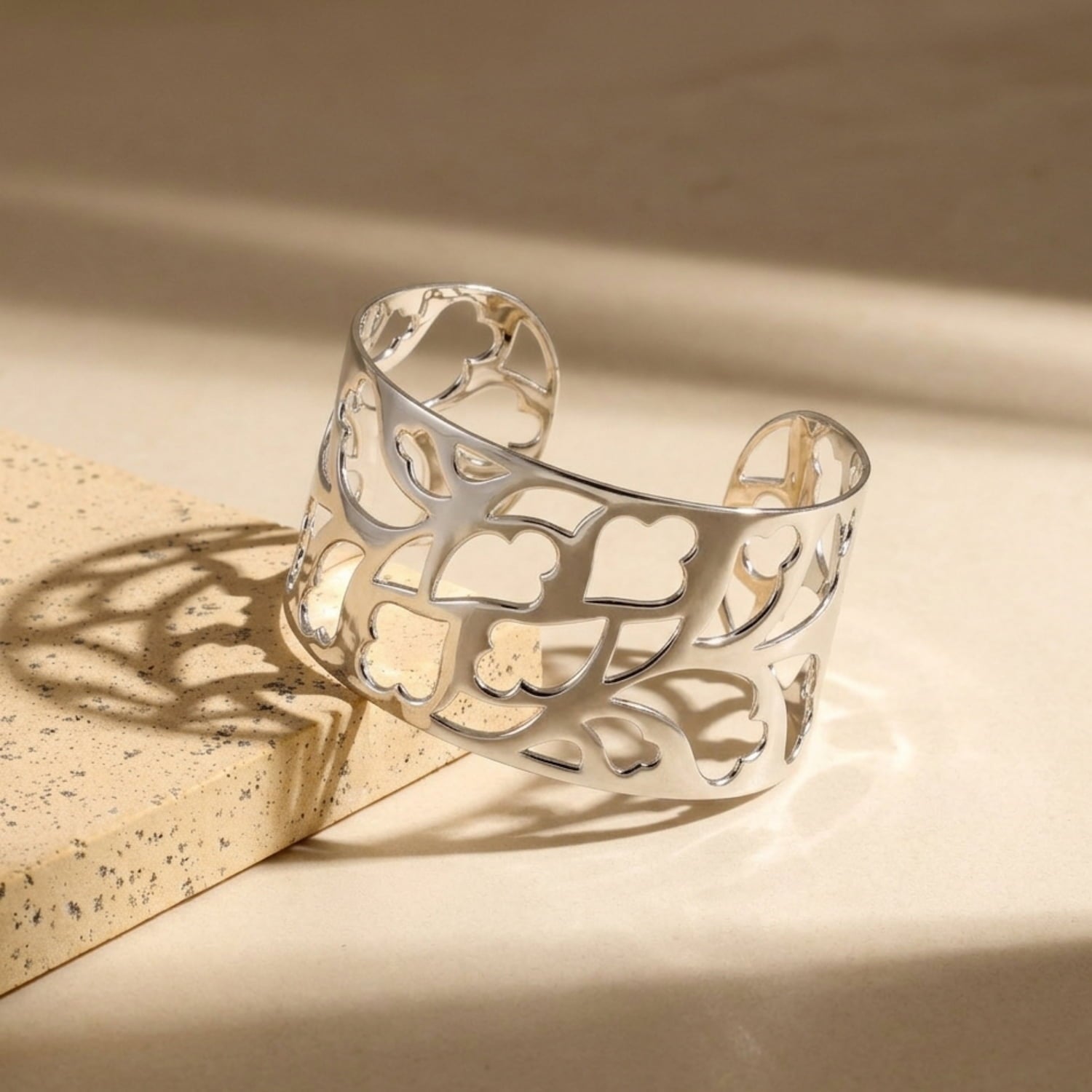 Sterling silver cuff bangle with an intricate openwork design inspired by Yorkshire hearts, showcasing expert craftsmanship in a contemporary silver bracelet style.