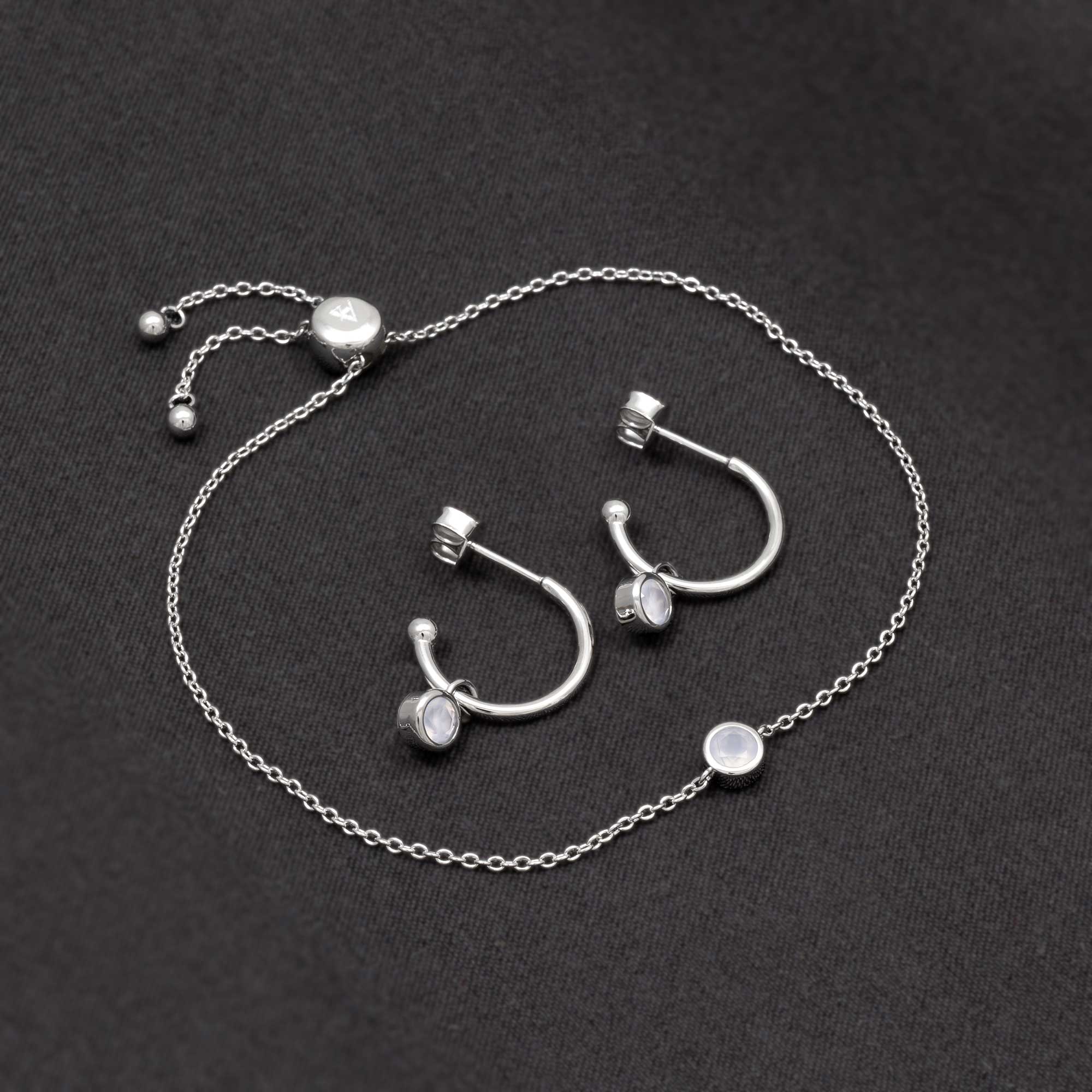 Delicate sterling silver hoop earrings and matching adjustable chain bracelet set, featuring soft aqua chalcedony stones for a subtle, modern touch.