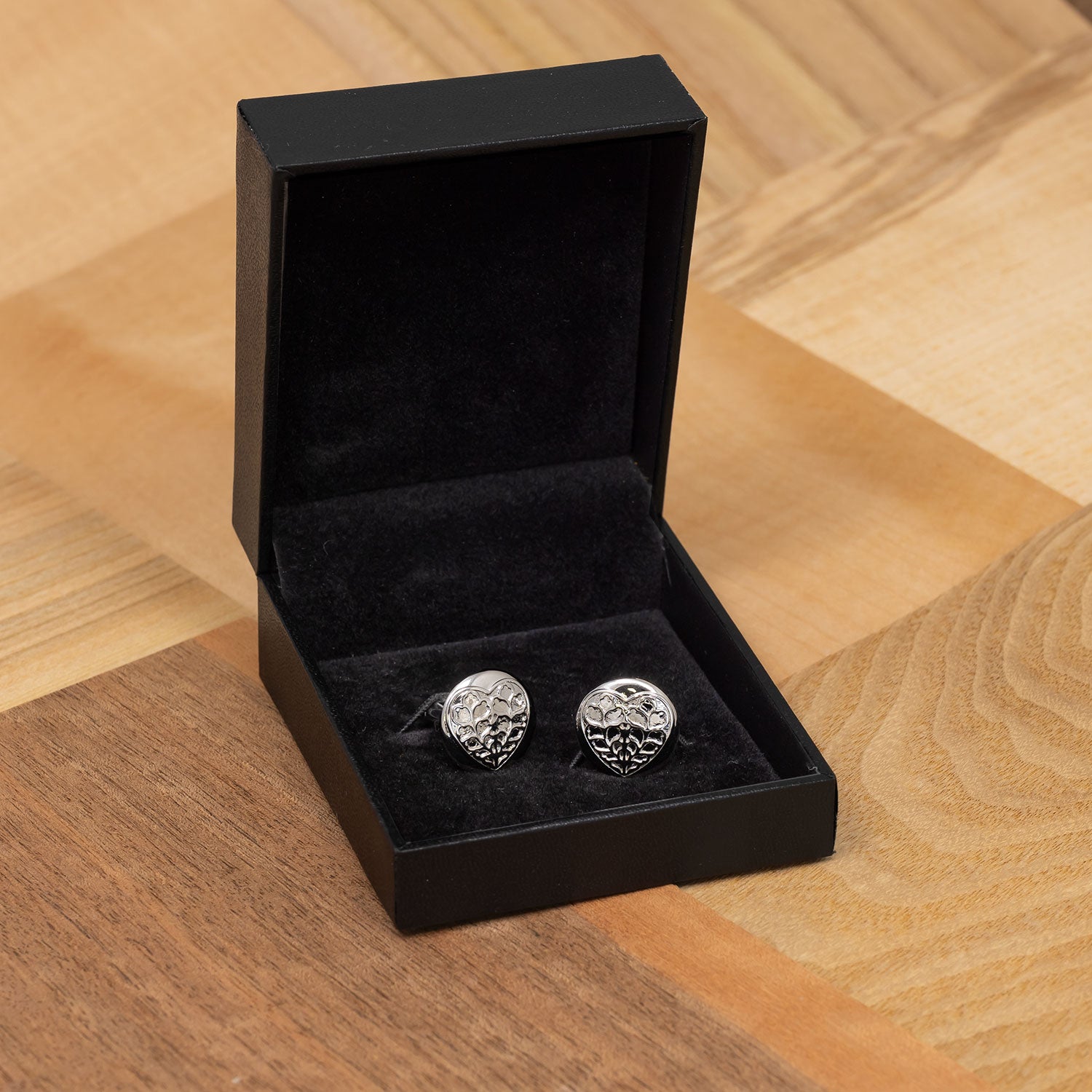 Pair of sterling silver cufflinks featuring round-shaped Heart of Yorkshire motifs with intricate detailing, presented in a black velvet-lined gift box.