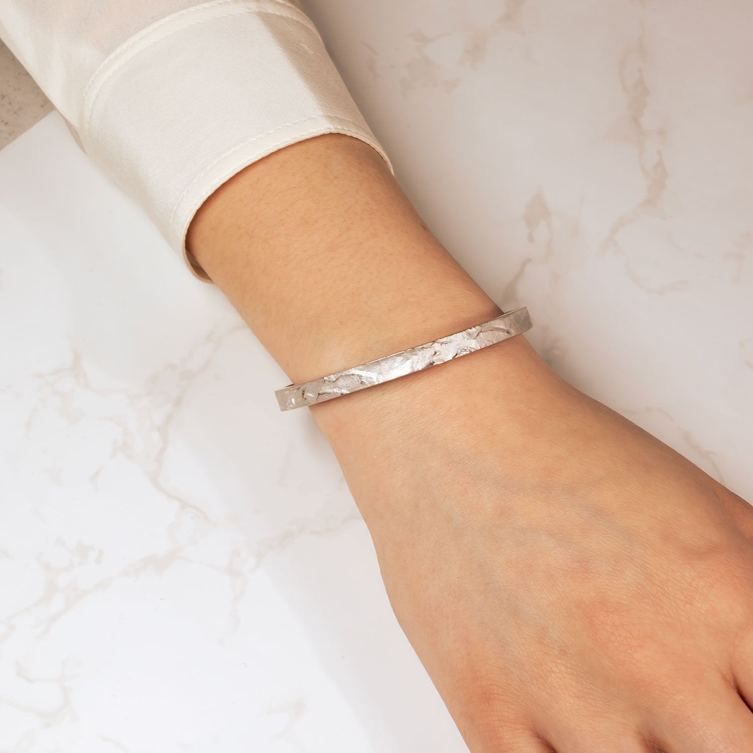 Azendi Malham silver bangle on wrist