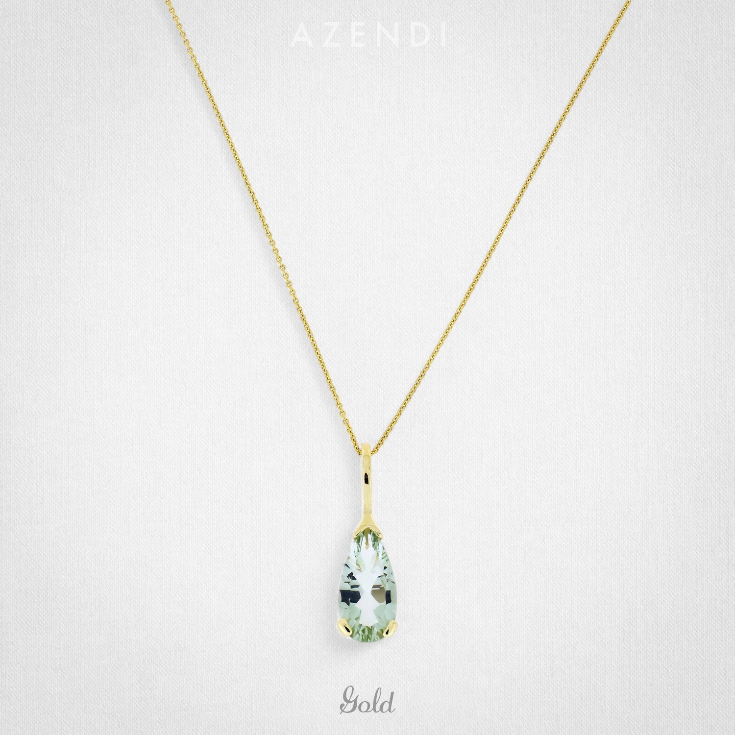 A refined 9 carat gold necklace featuring a green amethyst teardrop pendant suspended from a delicate chain, exemplifying elegant and sculptural jewellery design.