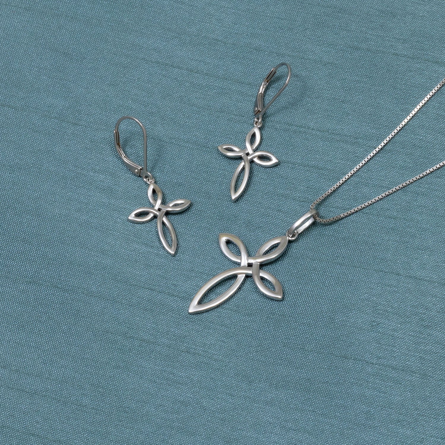 Sterling silver drop earrings featuring an openwork Celtic cross design, showcasing a sleek and refined silhouette inspired by traditional motifs in contemporary jewellery.
