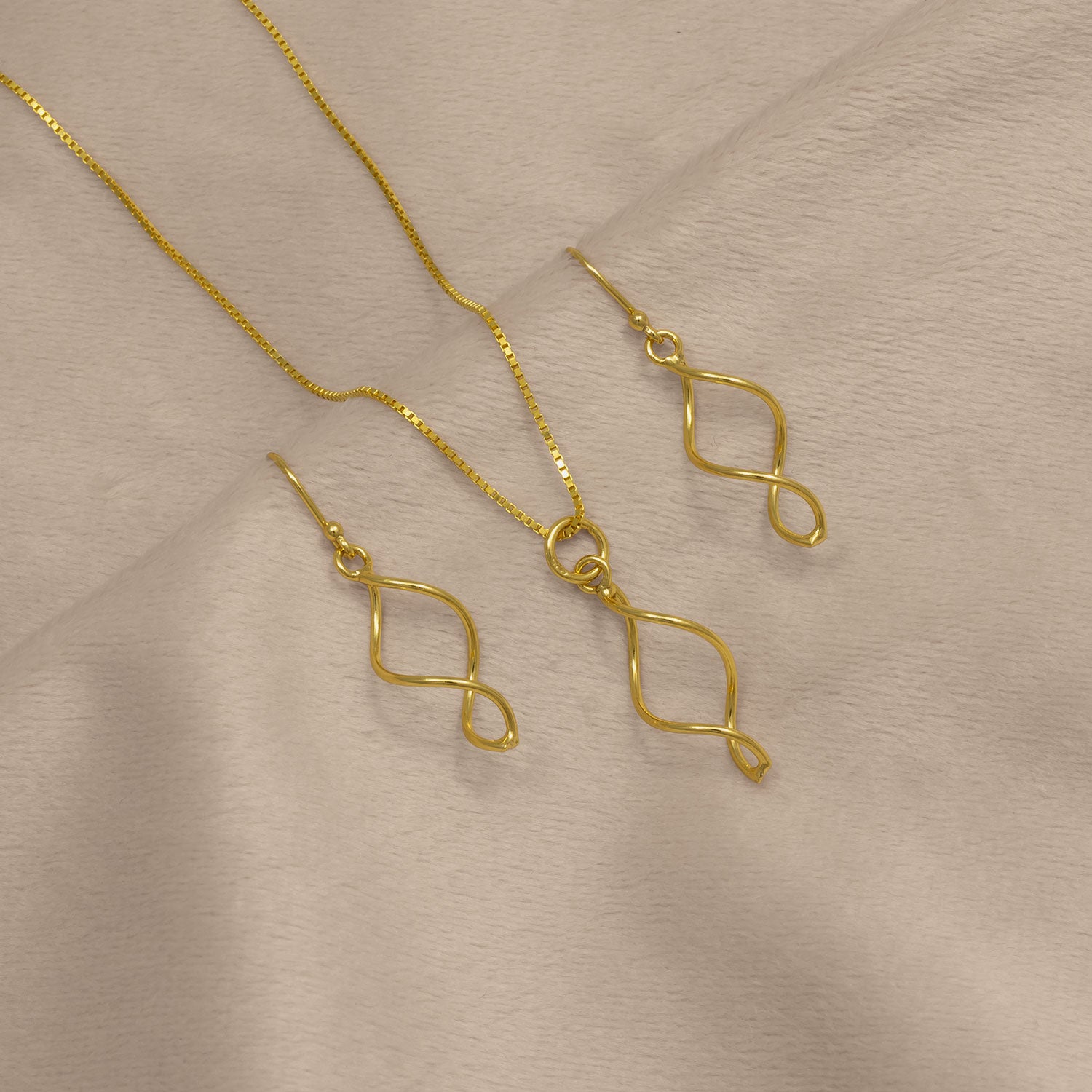 Simple Twist Drop Earring - Yellow Gold Vermeil displayed alongside a matching pendant on a delicate gold vermeil chain, both featuring elegant twisted drop shapes.