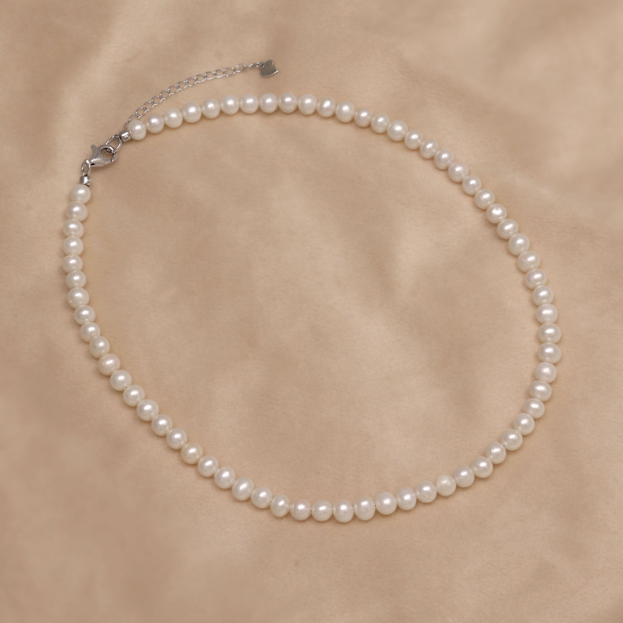 Pearl necklace on a beige background