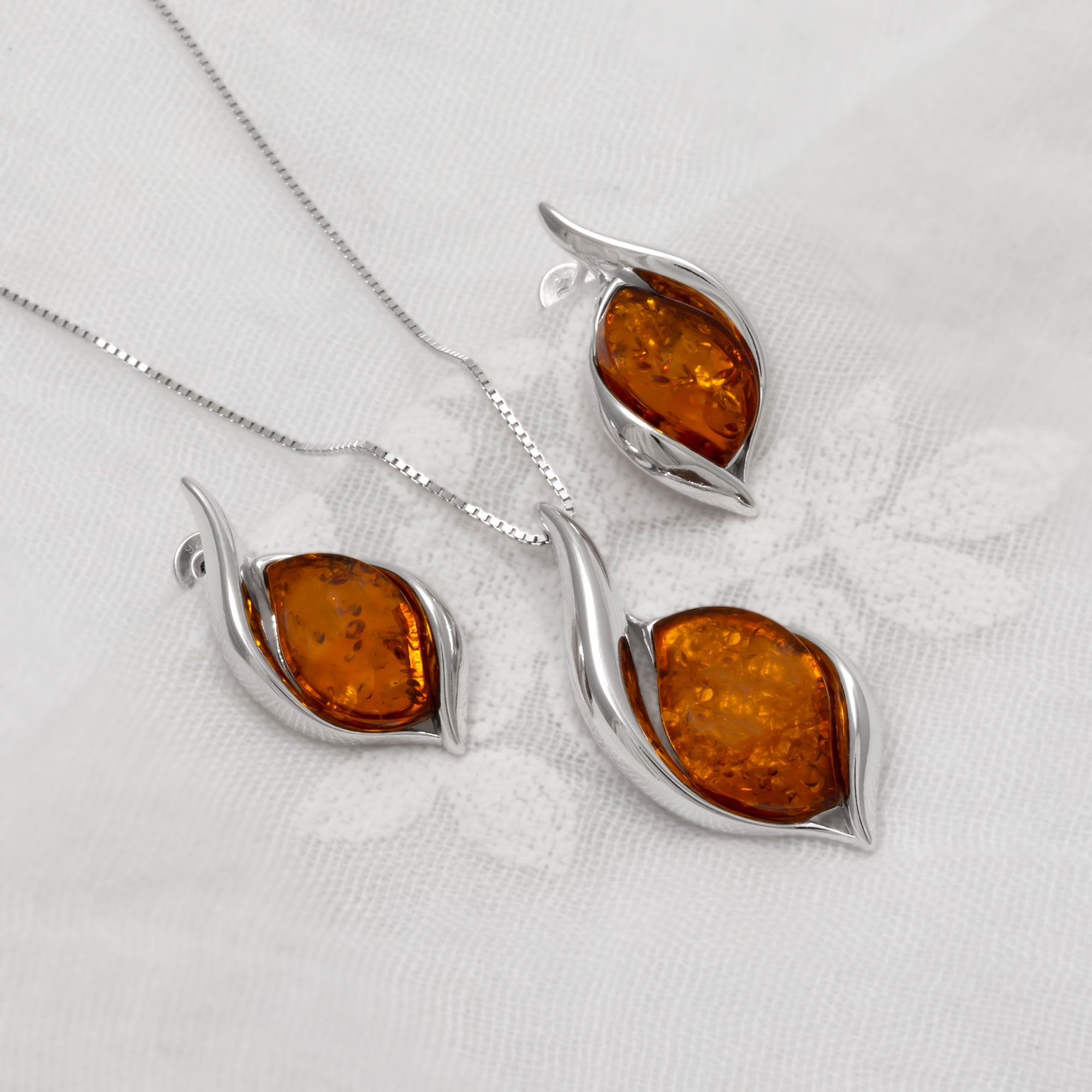Jewellery set with amber stones on a white background