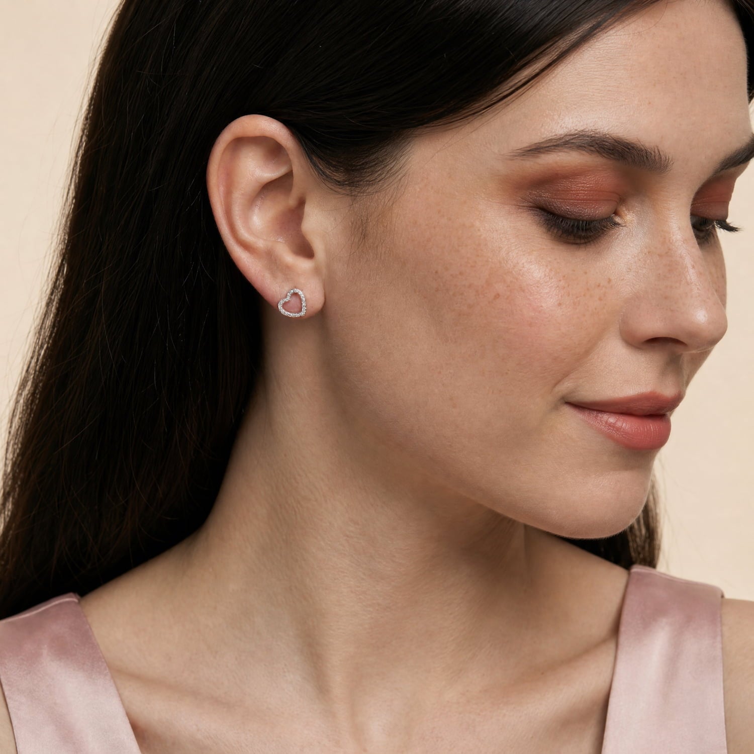 Model wears heart-shaped textured silver earrings