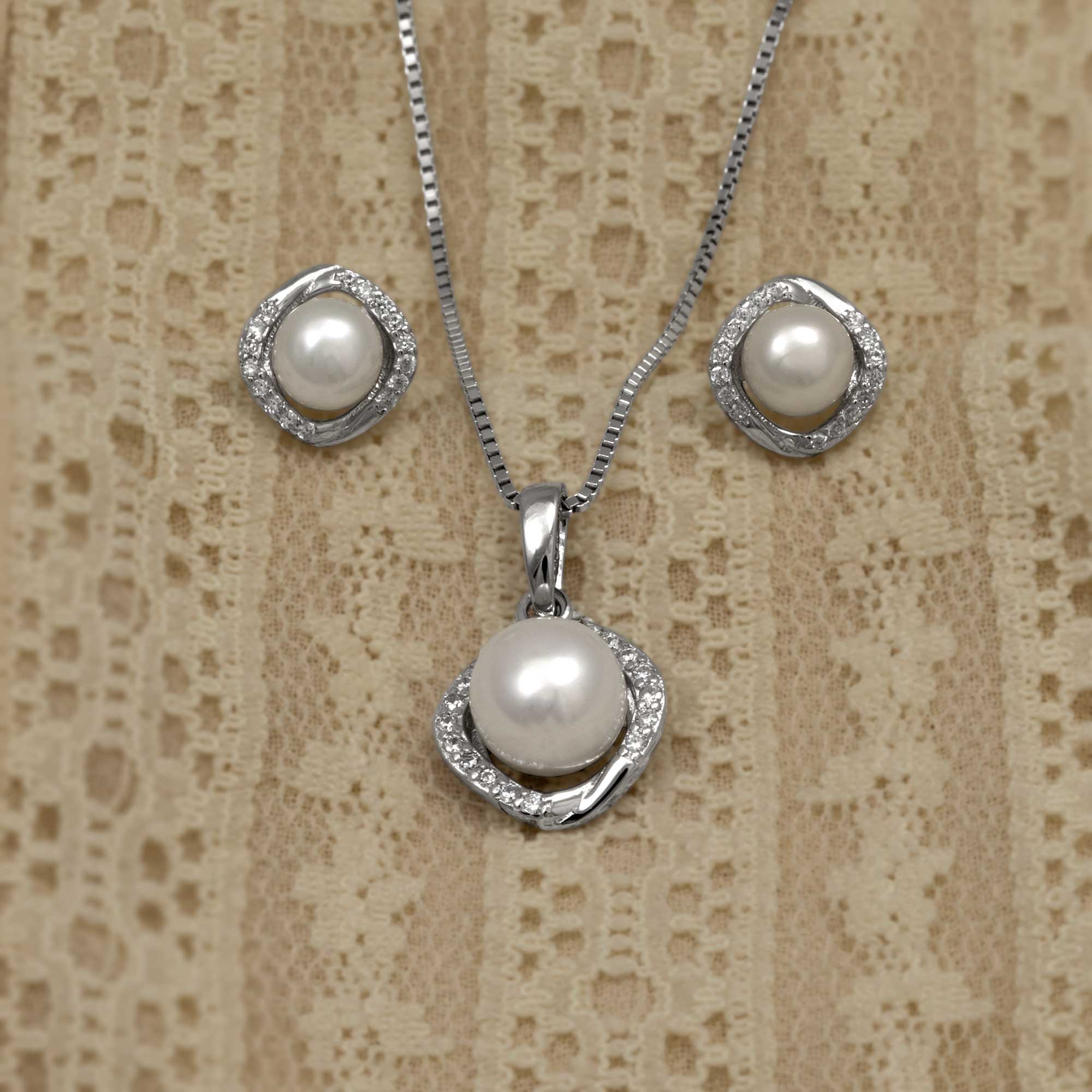 Silver necklace and earrings with a round freshwater pearl pendant, accented with cubic zirconia
